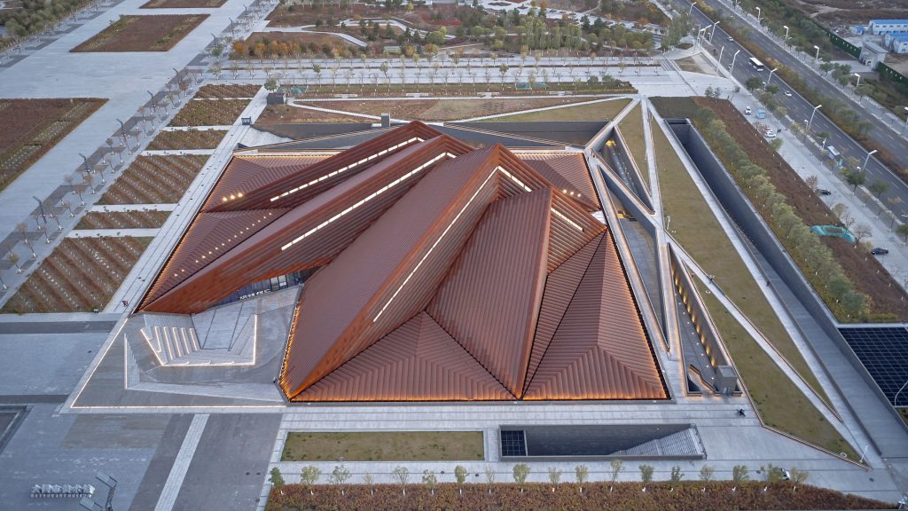 Foster + Partners shelters subterranean art gallery with pyramidal roofscape